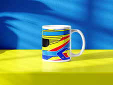 Fernando Alonso F1 helmet mug design in a minimalist style, featuring a blue and yellow background with blue, yellow and red livery with wing graphics, inspired by his Aston Martin 2024 Formula 1 helmet.